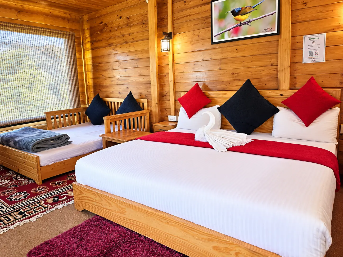 Wooden resort room with bed, dining table and warm interior